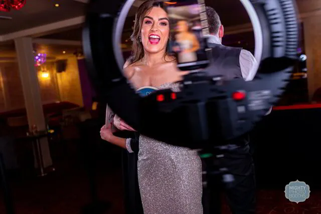 a bride posing for a 360 photo booth in her wedding in frisco texas