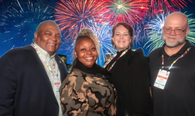 four people smiling for an ai photo booth with an ai generated fireworks backdrop