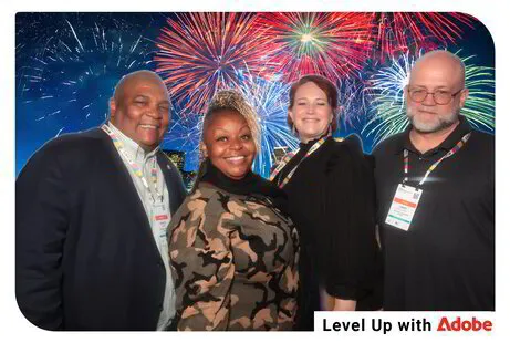 four people posing for a green screen photo booth with fireworks backdrop