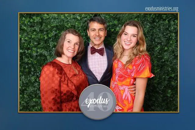 three people smiling for a photo portrait studio in a corporate event