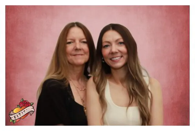 two women smiling for a photo portrait studio in a corporate event
