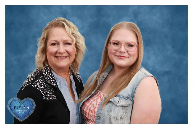 two women smiling for a photo portrait studio in a corporate event