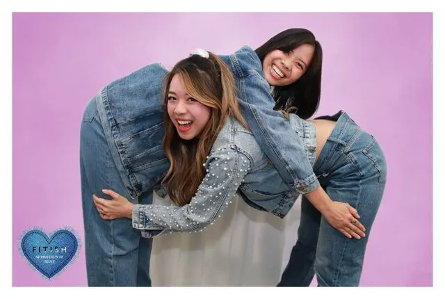 two women posing for a photo portrait studio in a corporate event