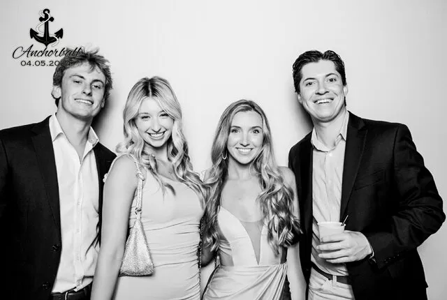 four people posing for a black and white photo booth in a party in fort worth texas