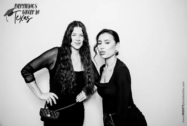 two women posing for a black and white photo booth in a corporate event in frisco texas