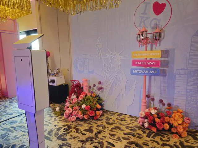 open air photo booth set up with a customized backdrop for a bat mitzvah