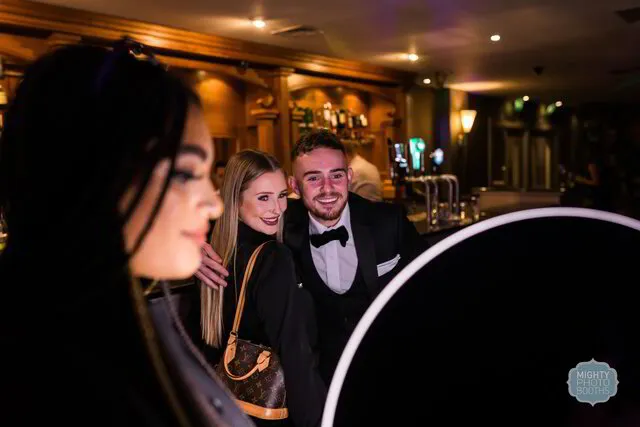 a couple posing for a roaming photo booth in a party in fort worth texas