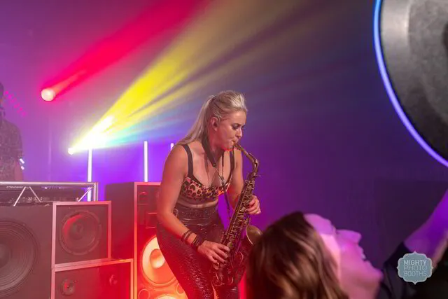 a woman playing saxophone caught by a roaming photo booth