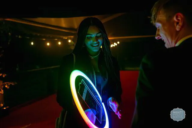 two people exploring the display panel of a roaming photo booth in a party in austin texas
