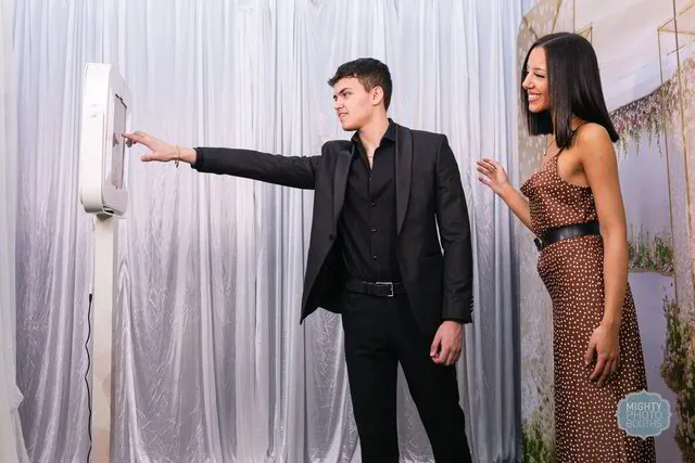 a couple posing for an open air photo booth in a wedding in austin texas