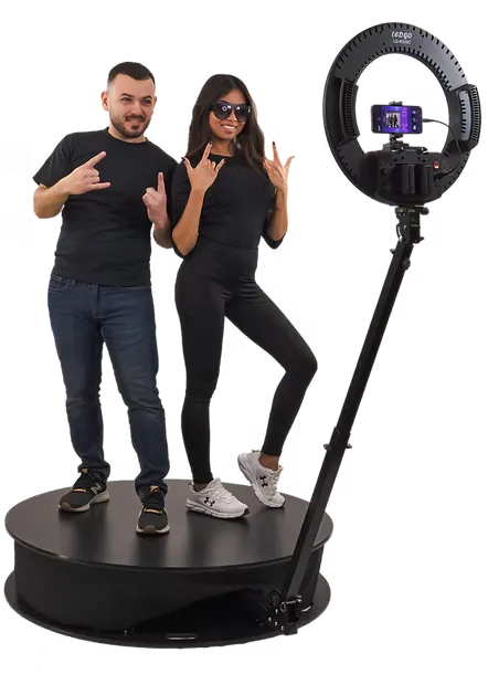 two people in a 360 photo booth platform